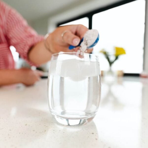 Powder supplement being added to water.