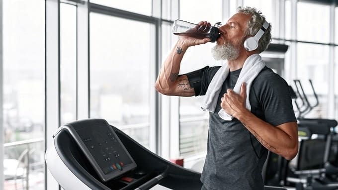 man drinking sports drink ketones