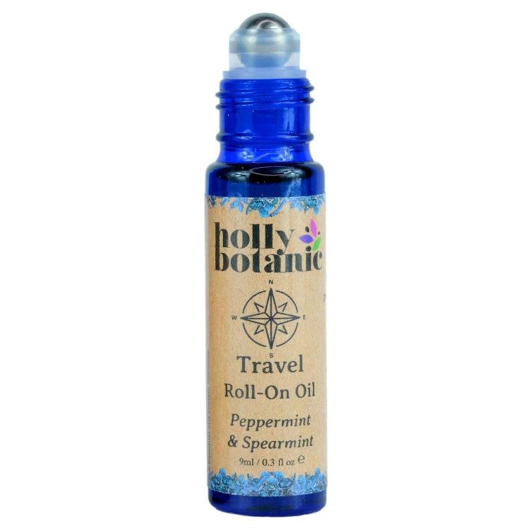 Travel roll on oil by Holly Botanic. 9ml, blue glass, recyclable bottle with metal roller and plastic lid. Lid off.